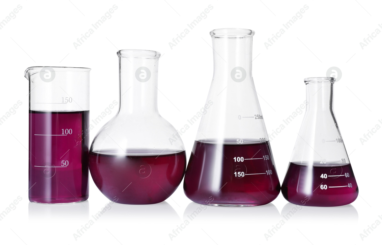 Photo of Different laboratory glassware with color liquid isolated on white