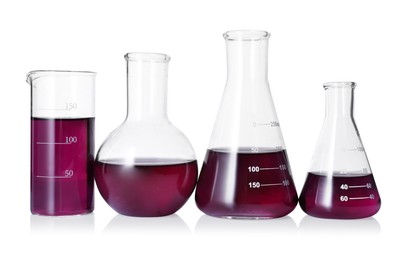 Photo of Different laboratory glassware with color liquid isolated on white