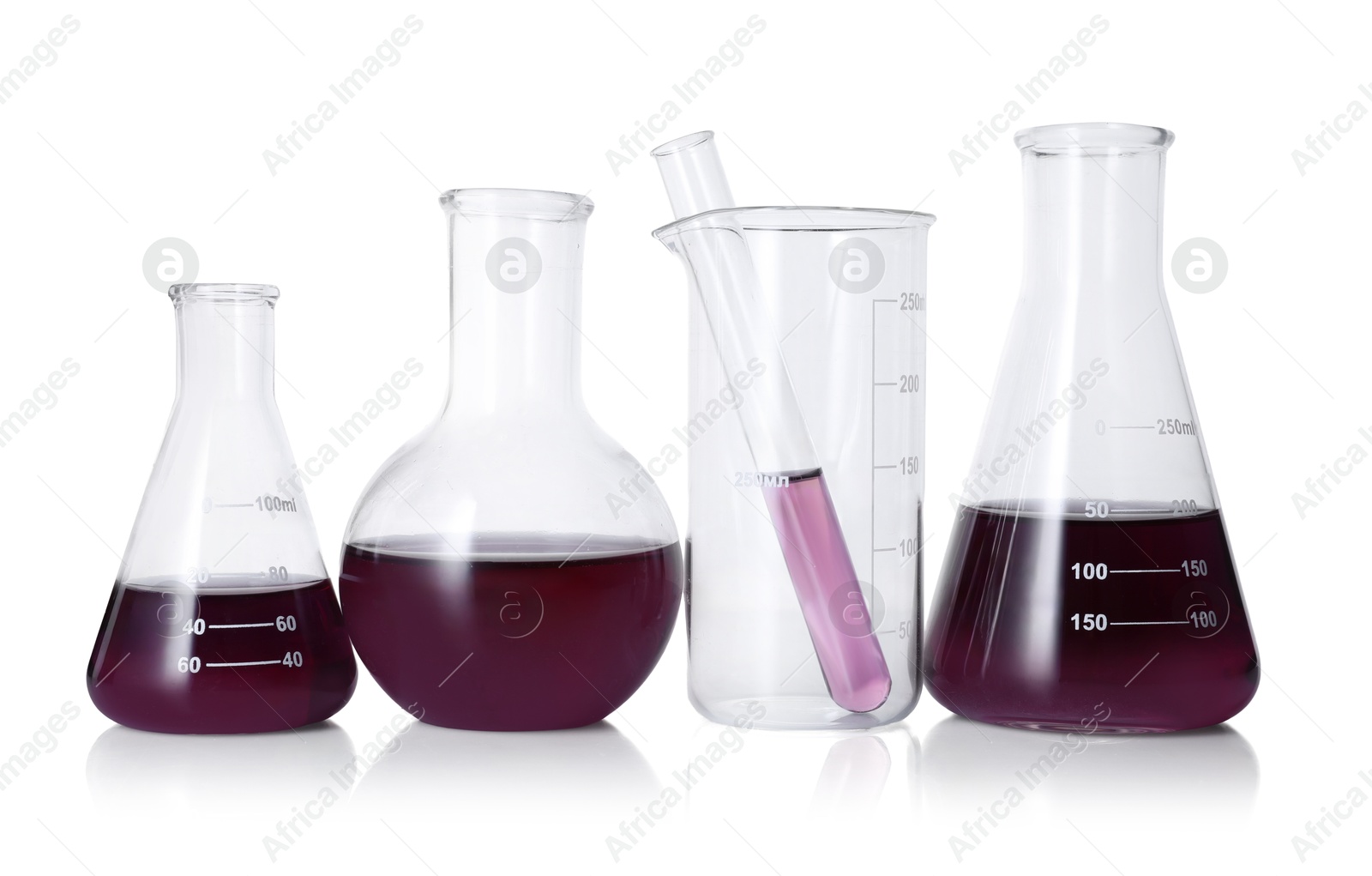 Photo of Different laboratory glassware with color liquid isolated on white