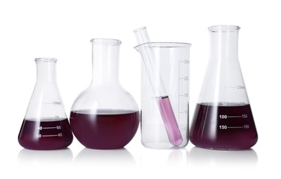 Photo of Different laboratory glassware with color liquid isolated on white