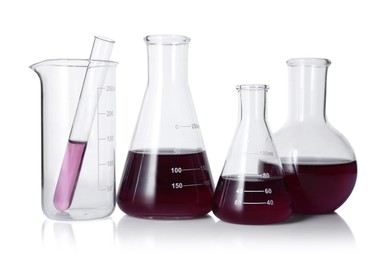 Photo of Different laboratory glassware with color liquid isolated on white
