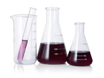 Photo of Different laboratory glassware with color liquid isolated on white