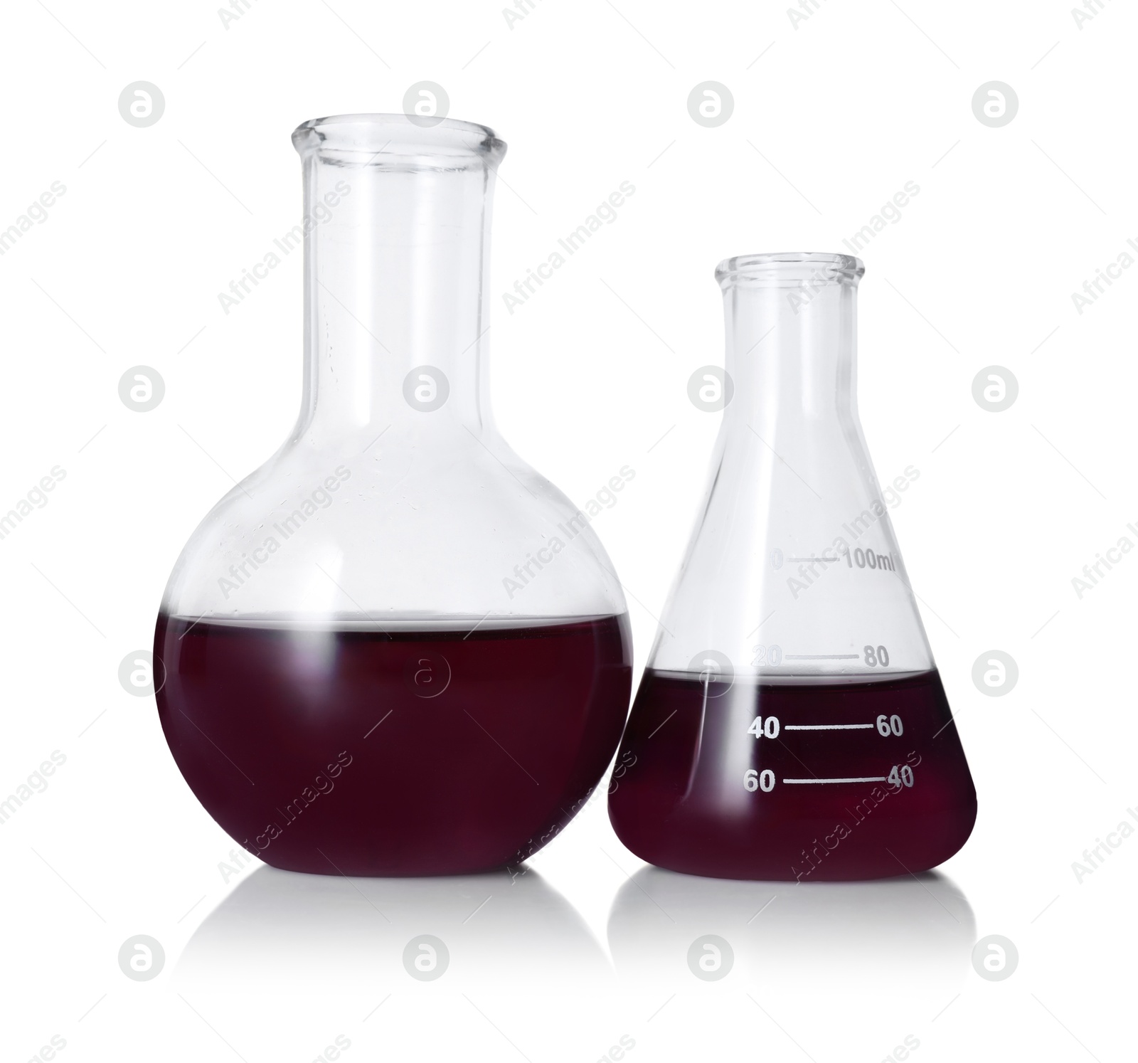 Photo of Different laboratory glassware with color liquid isolated on white