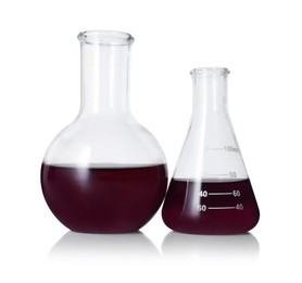Photo of Different laboratory glassware with color liquid isolated on white