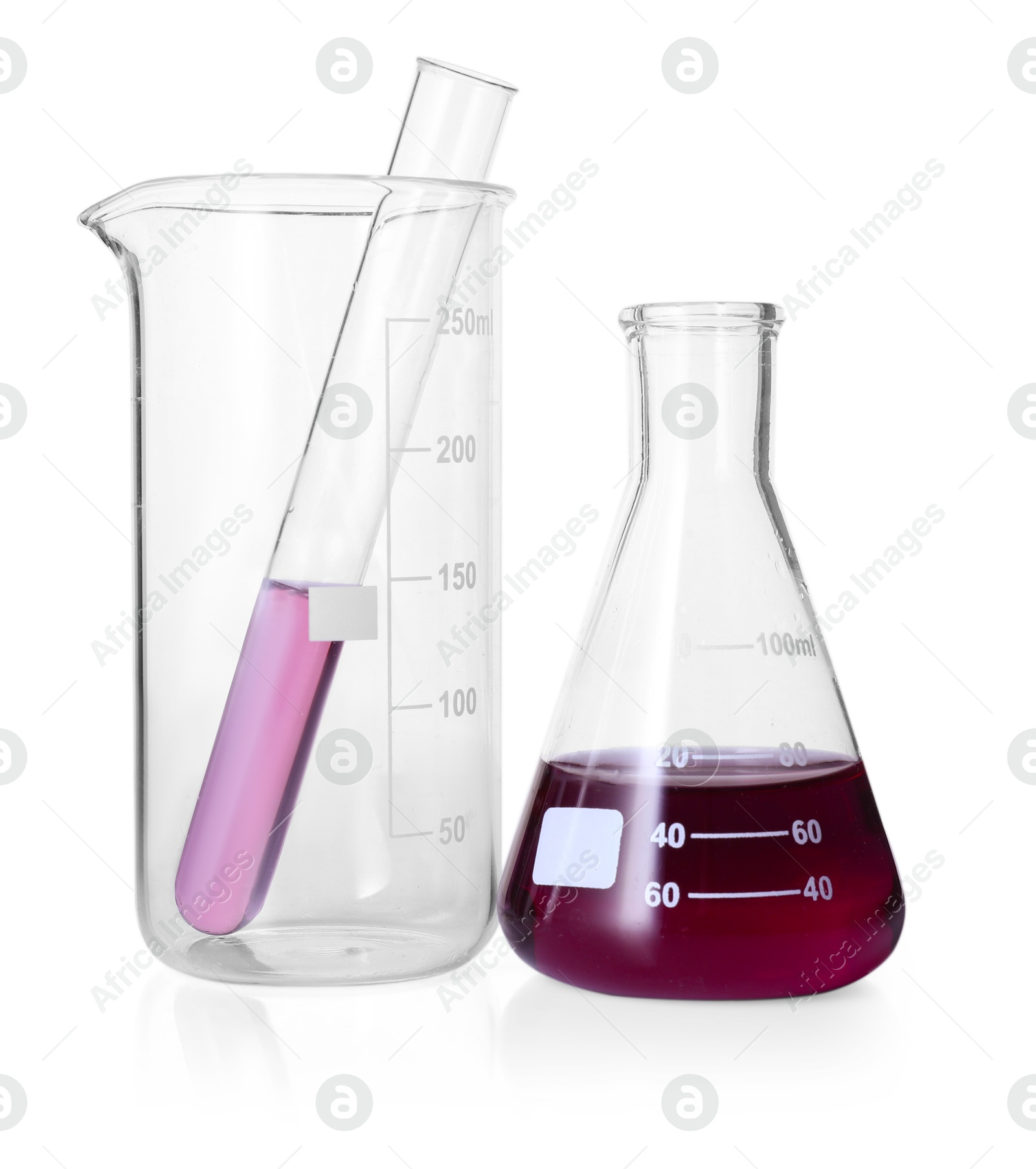 Photo of Different laboratory glassware with color liquid isolated on white