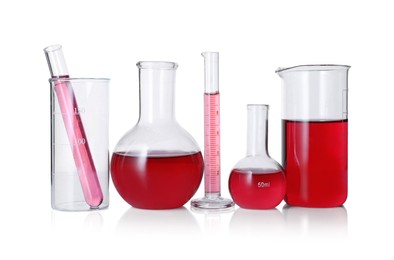 Photo of Different laboratory glassware with red liquid isolated on white