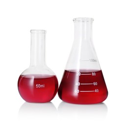 Photo of Different laboratory glassware with red liquid isolated on white