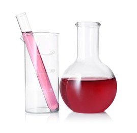 Photo of Different laboratory glassware with red liquid isolated on white