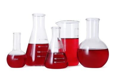 Photo of Different laboratory glassware with red liquid isolated on white
