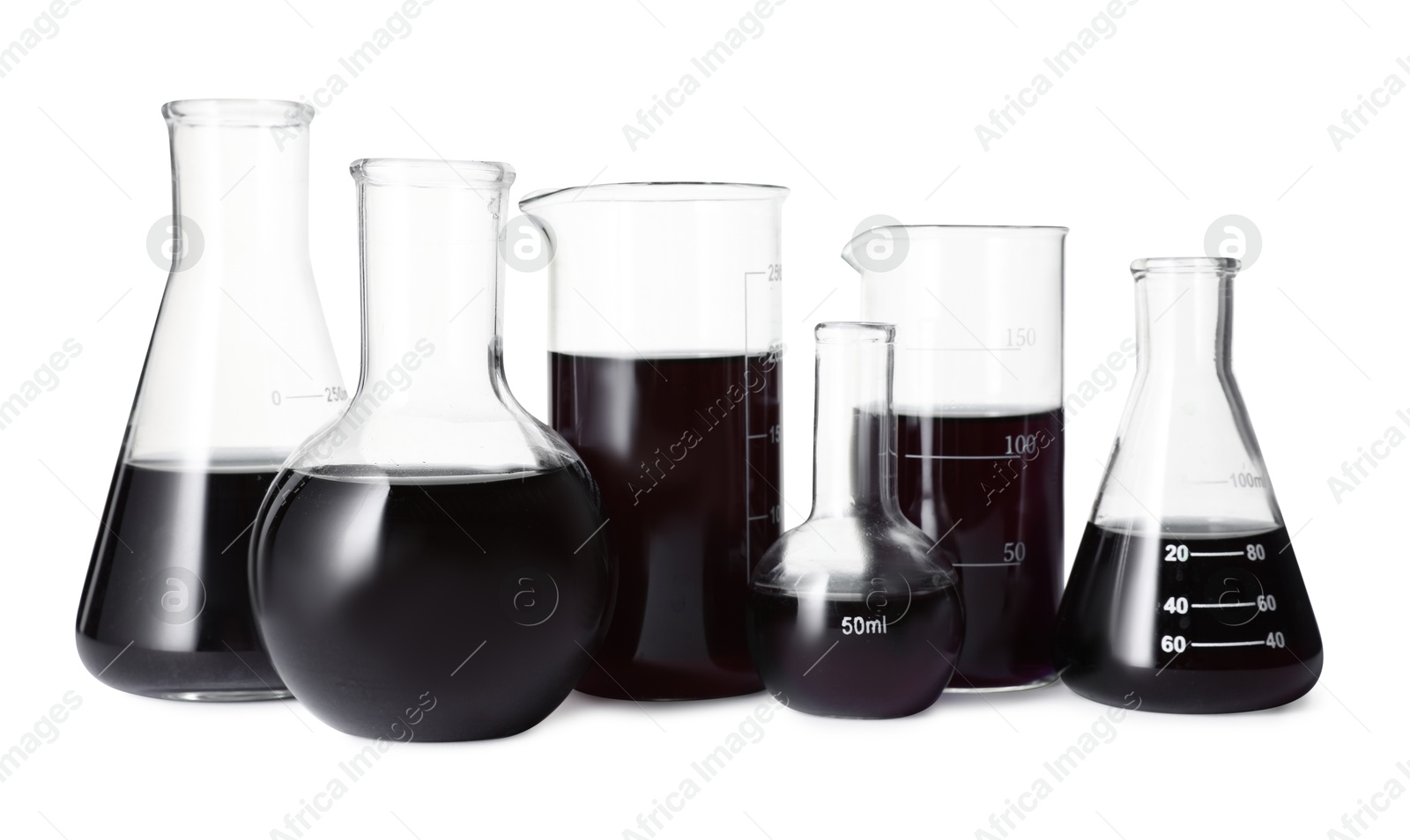 Photo of Different laboratory glassware with black liquid isolated on white