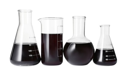 Photo of Different laboratory glassware with black liquid isolated on white