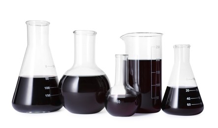 Photo of Different laboratory glassware with black liquid isolated on white
