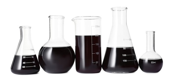Photo of Different laboratory glassware with black liquid isolated on white