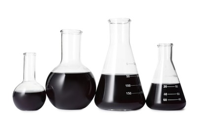 Photo of Different laboratory glassware with black liquid isolated on white