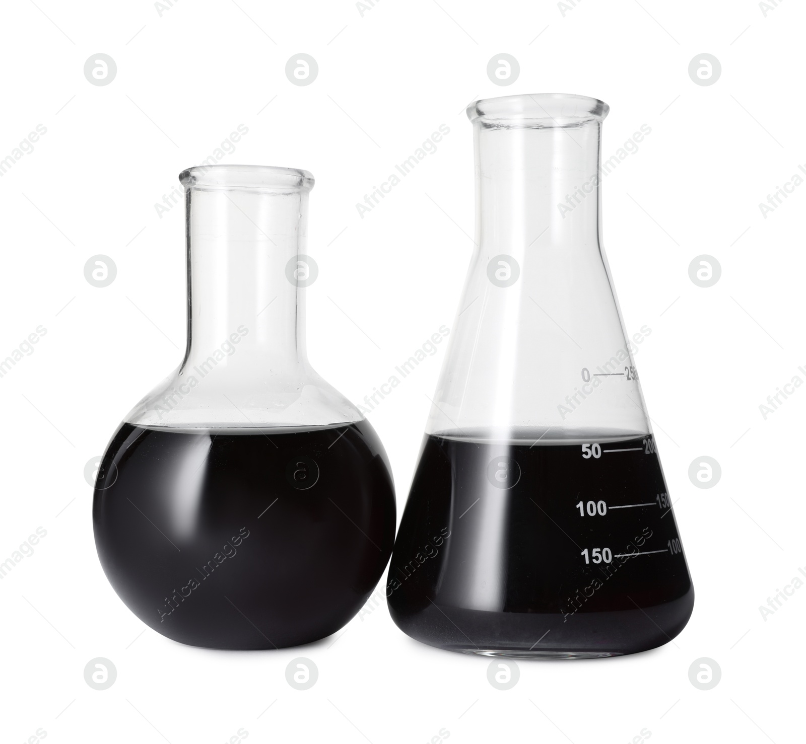 Photo of Different laboratory glassware with black liquid isolated on white