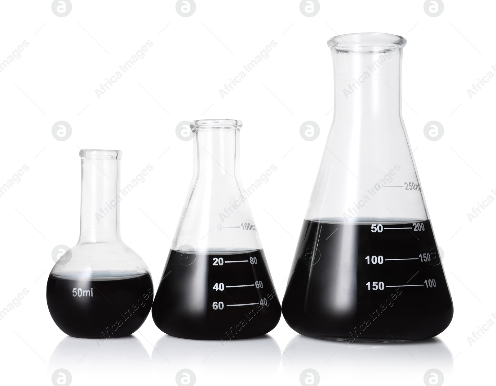 Photo of Different laboratory glassware with black liquid isolated on white