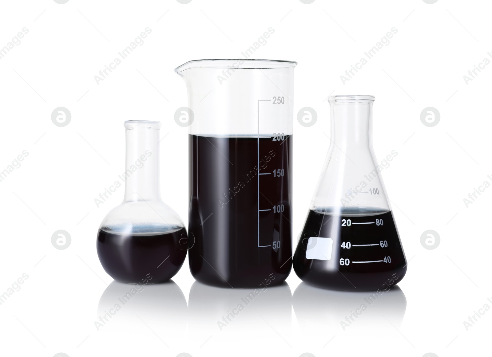 Photo of Different laboratory glassware with black liquid isolated on white