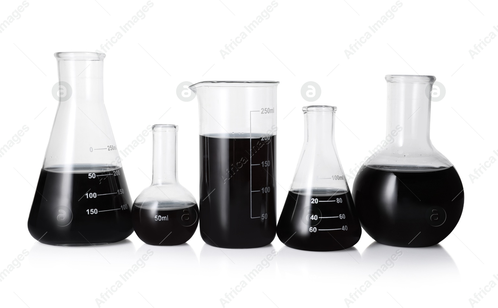Photo of Different laboratory glassware with black liquid isolated on white