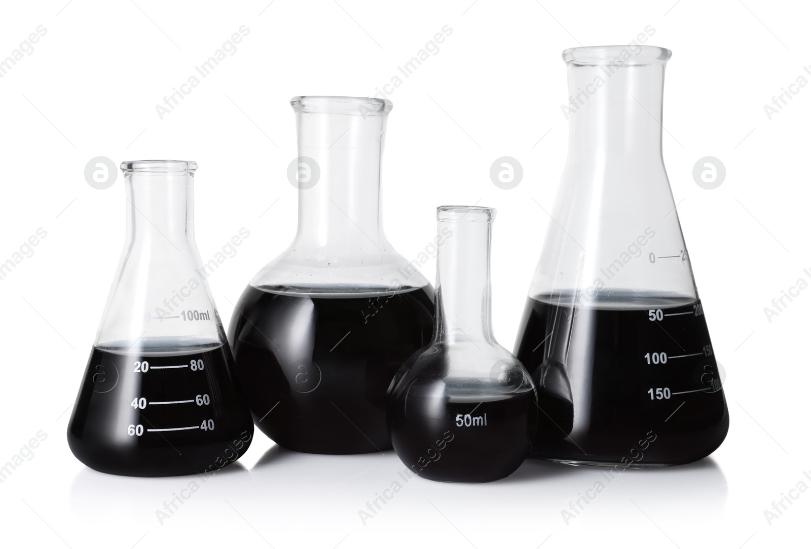 Photo of Different laboratory glassware with black liquid isolated on white