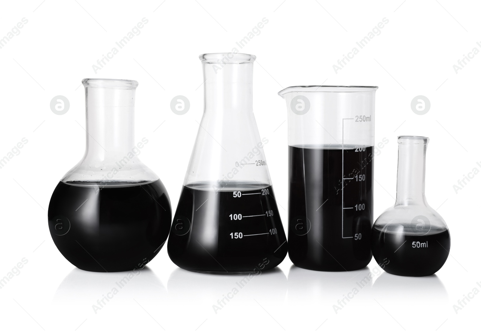 Photo of Different laboratory glassware with black liquid isolated on white