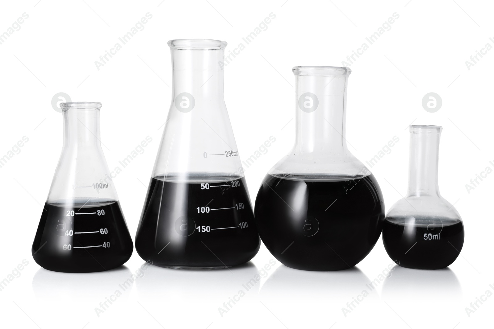 Photo of Different laboratory glassware with black liquid isolated on white