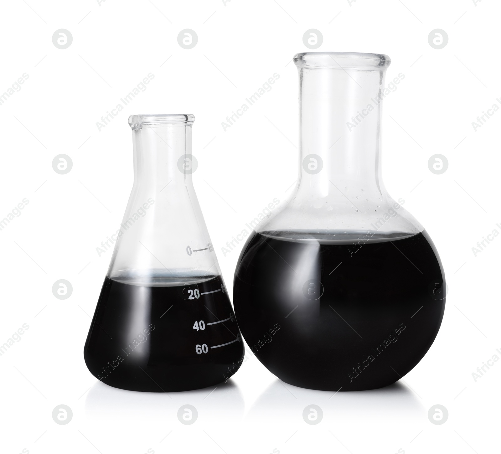 Photo of Different laboratory glassware with black liquid isolated on white