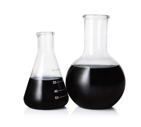 Photo of Different laboratory glassware with black liquid isolated on white