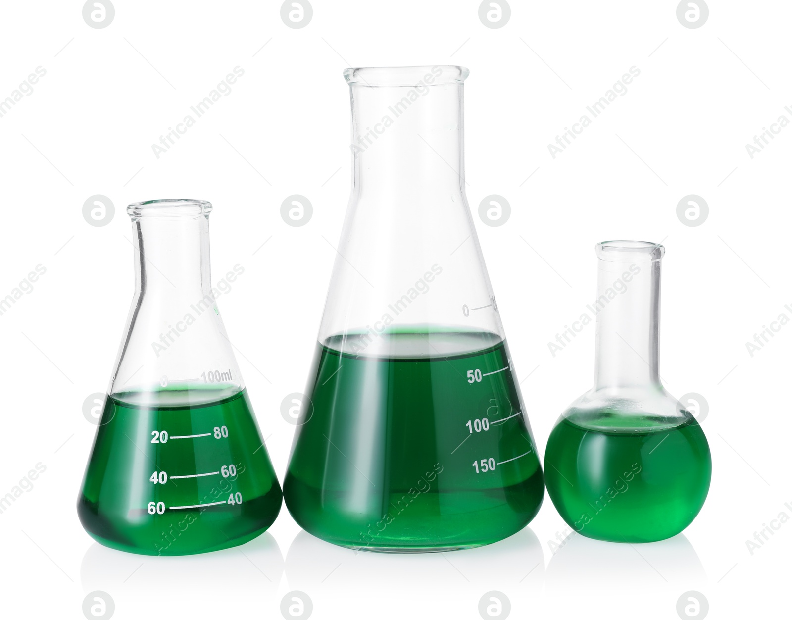Photo of Different laboratory glassware with green liquid isolated on white