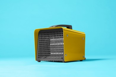Photo of Electric fan heater on light blue background