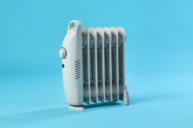 Photo of One electric heater on light blue background