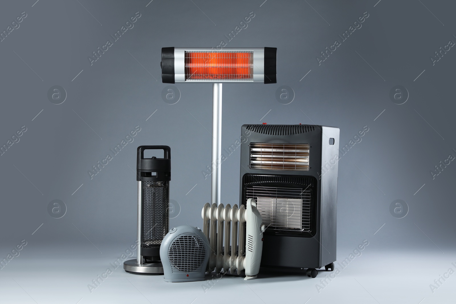 Photo of Different types of electric heaters on grey background