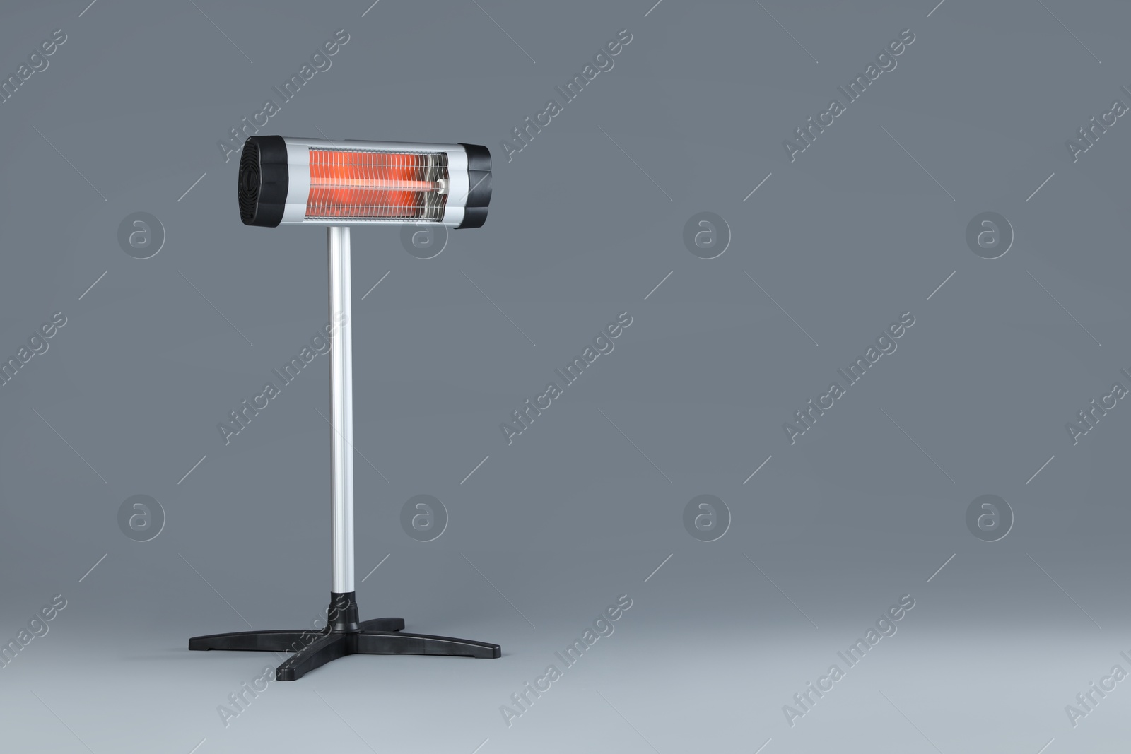 Photo of Electric infrared heater on grey background. Space for text