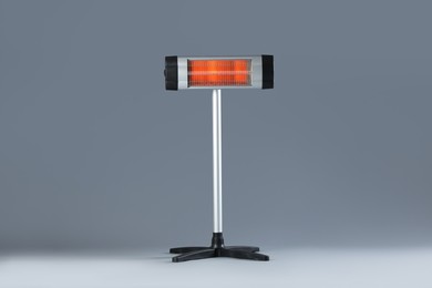 Photo of One electric infrared heater on grey background