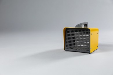 Photo of One electric fan heater on grey background. Space for text