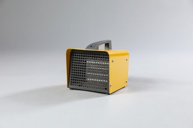 Photo of One electric fan heater on grey background