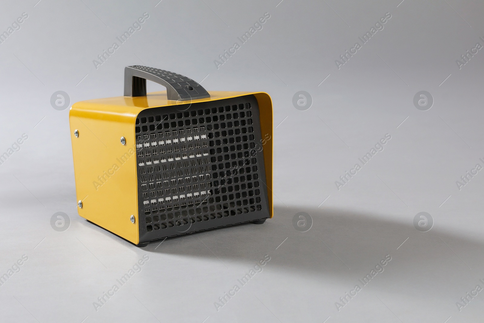 Photo of One electric fan heater on grey background. Space for text