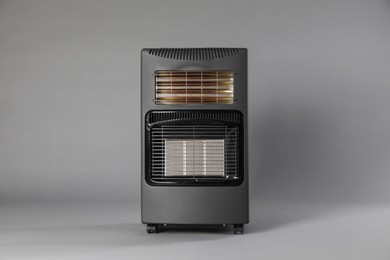 Photo of One electric heater on grey background. Domestic appliance