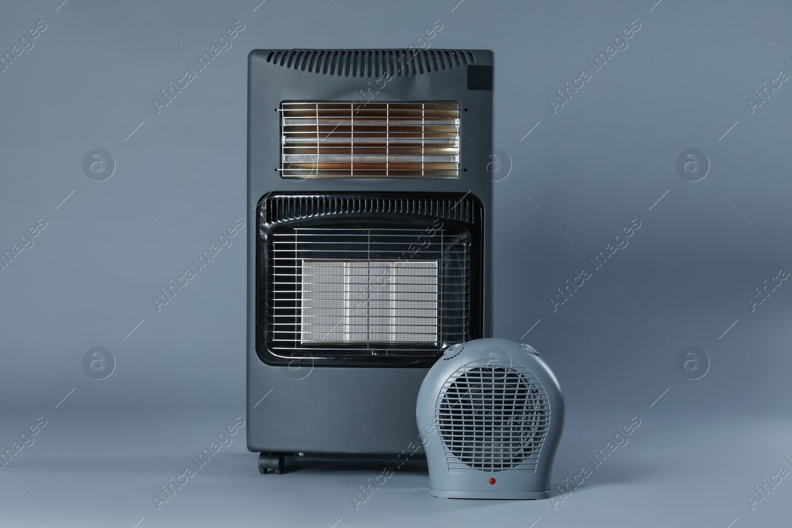 Photo of Different types of electric heaters on grey background