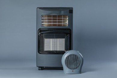 Photo of Different types of electric heaters on grey background