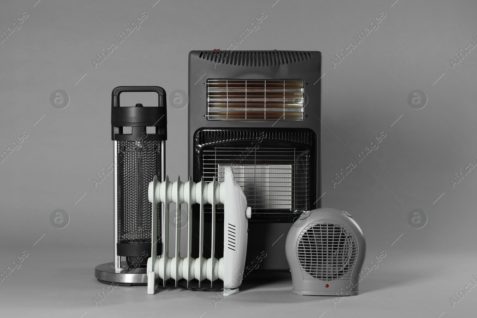 Photo of Different types of electric heaters on grey background
