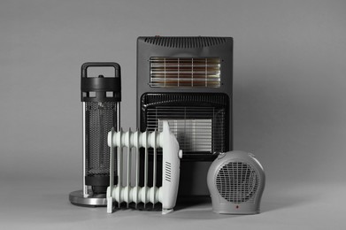 Photo of Different types of electric heaters on grey background