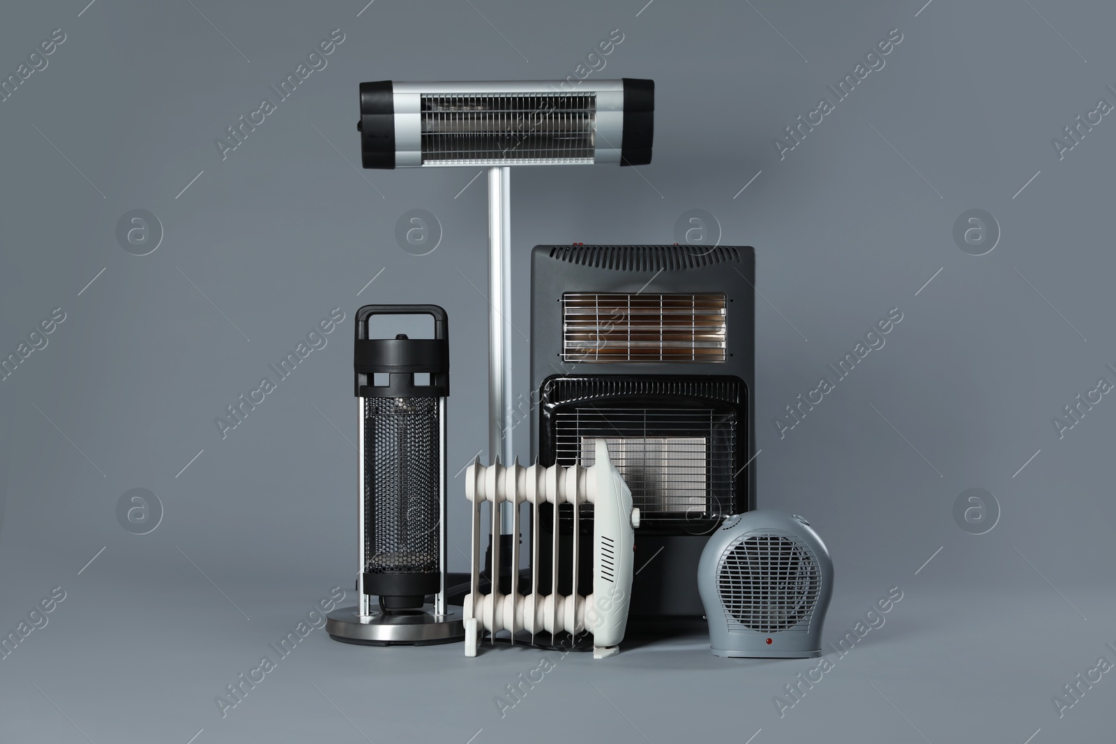 Photo of Different types of electric heaters on grey background
