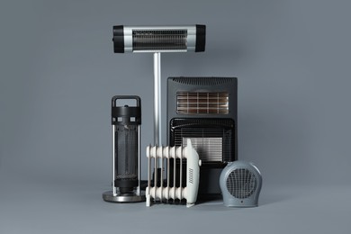 Photo of Different types of electric heaters on grey background
