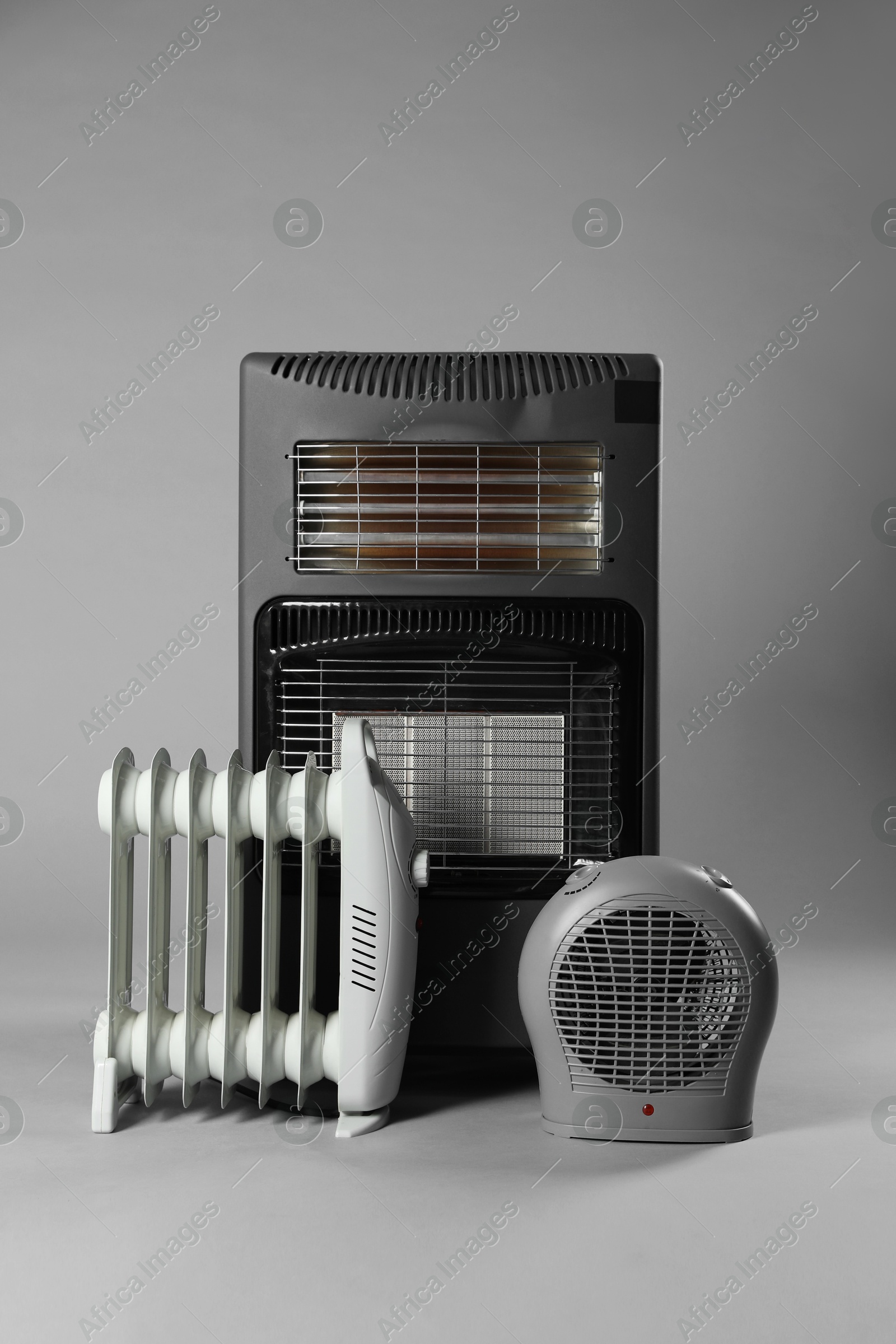 Photo of Different types of electric heaters on grey background