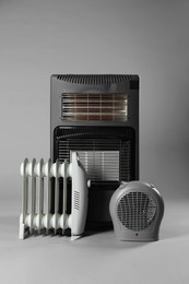 Photo of Different types of electric heaters on grey background