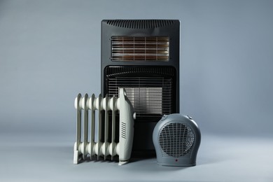 Photo of Different types of electric heaters on grey background