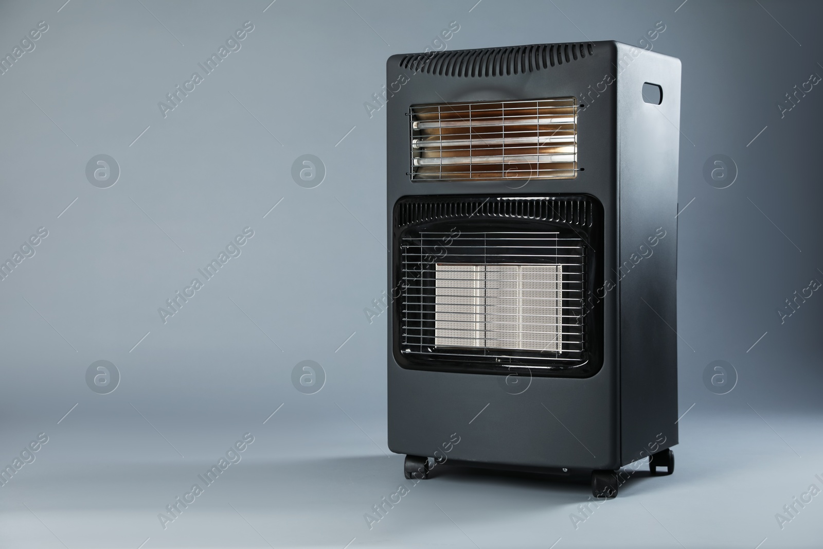 Photo of One electric heater on grey background. Space for text
