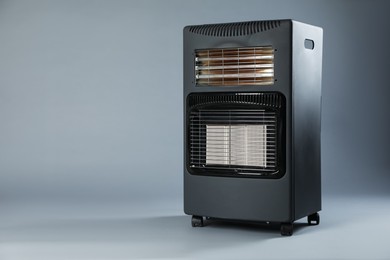 Photo of One electric heater on grey background. Space for text