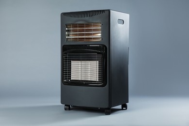Photo of One electric heater on grey background. Domestic appliance