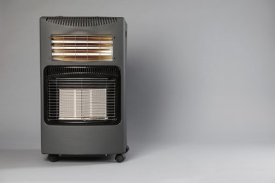 Photo of One electric heater on grey background. Space for text